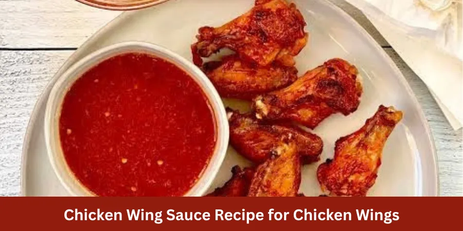 A serving of finished chicken wings arranged naturally on a plate against a clean neutral background with soft warm lighting, showing the completed dish in a clear recipe presentation.