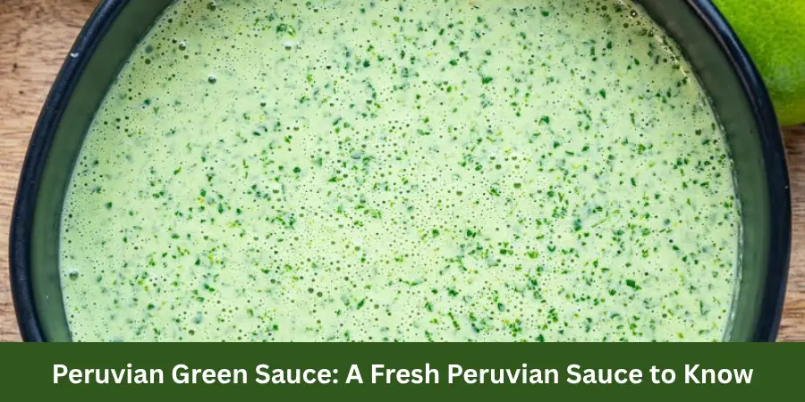 A shallow bowl of fresh green sauce on a neutral countertop with a simple spoon beside it and a softly blurred background.